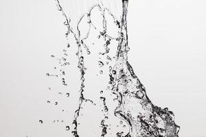 Falling water on a white background photo