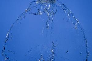 Falling water on a blue background photo