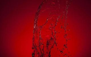 Falling water on a red background photo