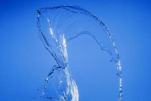 Falling water on a blue background photo