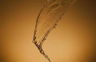 Falling water on a golden background photo