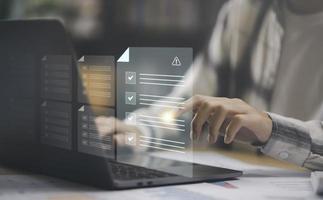Businessman checking the steps through a virtual online document with a list of checkboxes Concepts of practices and policies, company articles of association Terms and Conditions, Finding errors photo