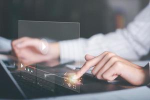 man working with laptop, to watch videos via wireless technology,Training, learning, teaching,virtual reality used in online video conferencing,Online streaming Watch videos on Internet photo