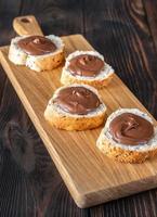 Slices of baguette with chocolate paste photo