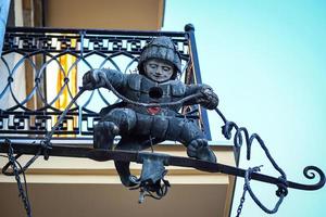 Creepy iron cavalier statue holding a wire on balcony of the old town of Vilnius, Lithuania photo