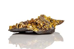 Macro mineral stone yellow Wulfenite on a white background photo