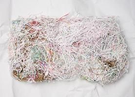 cut paper sheets into small strips, waste. Fragile packaging paper photo