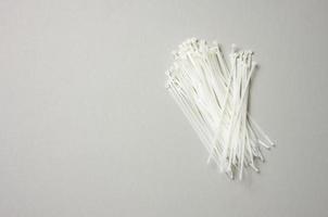 stack of plastic cable ties on gray background. View from above photo