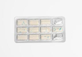 rectangular pieces of gum in a blister pack on a white background photo