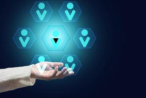 female hand on a dark background and the hierarchical structure of the team photo