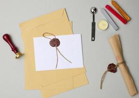 sealed white envelope with brown wax seal on beige background photo