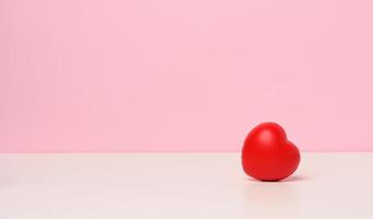 one red heart on a pink background, copy space photo