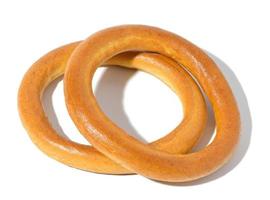 Baked round bagel made of white wheat flour on a white isolated background photo