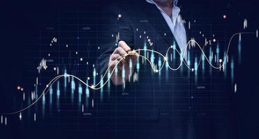 Graph of price growth and indicators. Analysis of indicators on a virtual screen by a businessman in a suit. Growth of business indicators, high profit photo