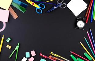 school supplies multicolored wooden pencils, notebook, paper stickers, paper clips, pencil sharpener photo