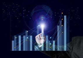 virtual hologram with charts and growing data. The man's hand touches. Concept of successful business, high income photo
