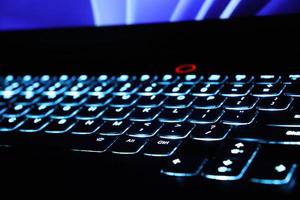 Close up monitor and backlit keyboard concept photo. Keys with glowing elements. photo