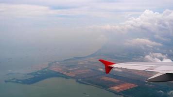 The aircraft departing from airport of Singapore, view from the airplane porthole. video