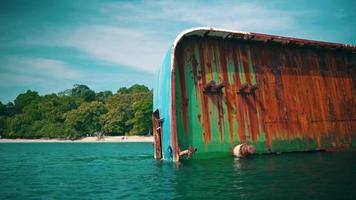 un' naufragio incagliato nel davanti di un isola pieno di verde alberi e blu mare video