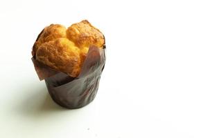 Vanilla cupcake muffin in wrapper on white background isolate. Copy space photo