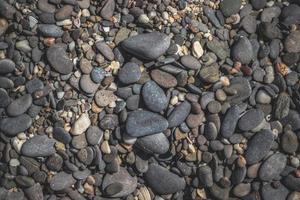 Pebble beach background, pebble stones texture photo