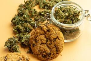 Cookie and cannabis buds, medical marijuana use. THC drug recreation photo