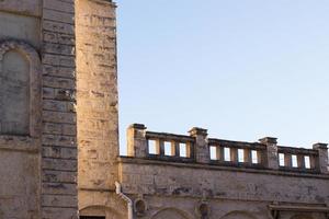 Old historical buildings. Stone ancient walls with blue sky background. Tourism concept photo