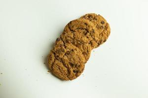 Sweet brown oatmeal cookies stack top view isolate on white background photo