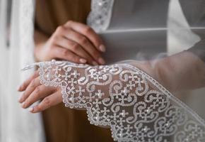 wedding veil close-up of embroidered pattern on hand. photo