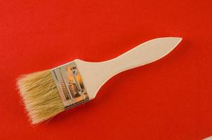 Painting brush on red background photo