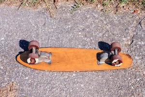 Old skateboard on the road photo