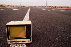 Old television on the road photo