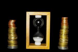 Hourglass and coins photo