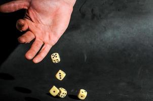 Hand throwing dices photo