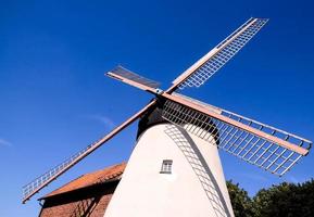 Traditional windmill under blue sky photo