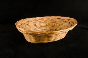 Wooden basket on black background photo