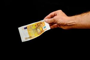 mano participación un euro billete de banco foto