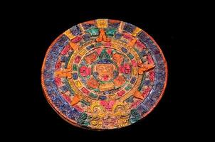 Mayan calendar on black background photo