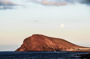 Cliffside in the ocean photo