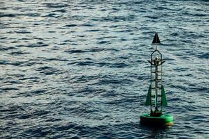 Green buoy in the ocean photo