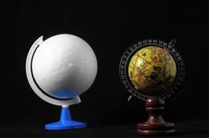 Two globes on black background photo