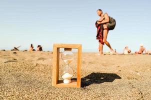 Hourglass on the sand photo