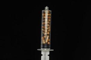 Syringe with capsules photo