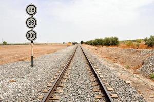 Railway tracks over gravel photo