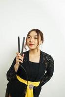 Asian woman styles her hair, photo