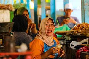 Yogyakarta, Indonesia in November 2022. Women on Baron Beach work as traders at the fish market. photo