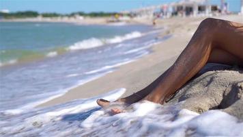 Woman legs closeup at beach during summer vacation video