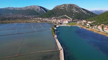 Aerial drone view of the salt pan in the city of Ston in Croatia. Fortified walls in the hills in the background. Salt fields. Ston Salt Works. Tourism near the Adriatic sea. Historic visits. video