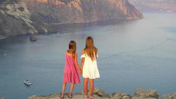 Children outdoor on edge of cliff seashore video
