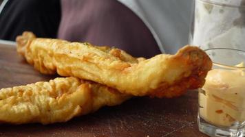 Fish fillet, chips and potato mash on table video